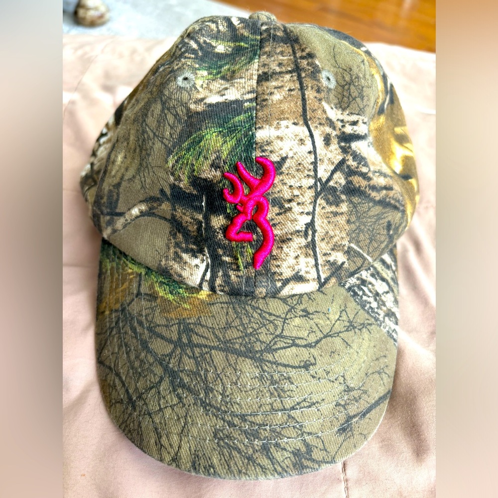 Browning for her. Camo cap. Hot pink under visor and puffed logo on front.